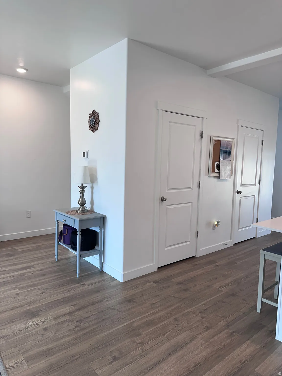 Warm wood-finish flooring complements crisp white walls and trim