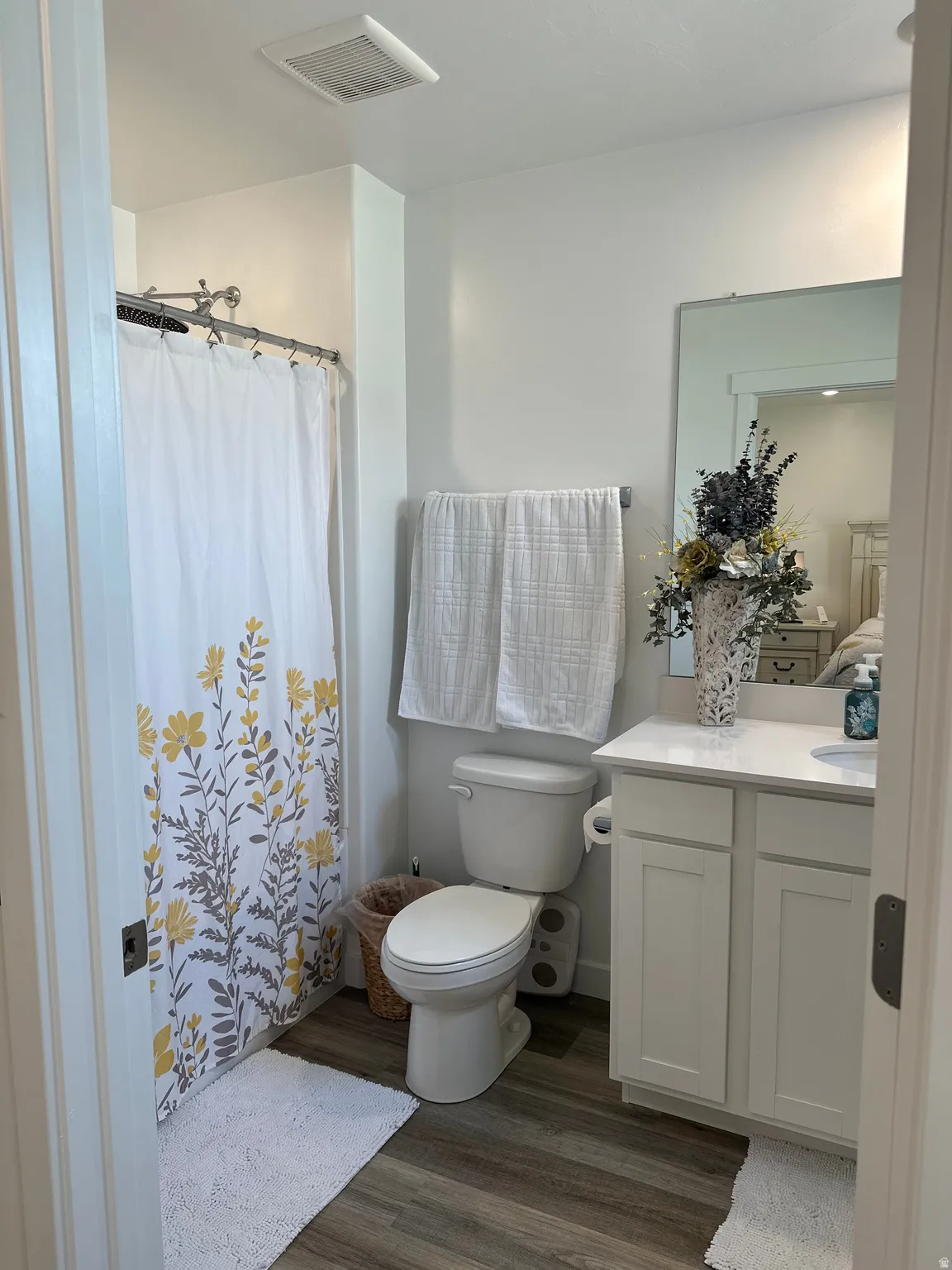 Bathroom featuring a white vanity with shaker-style cabinetry, a white countertop, and a rectangular sink