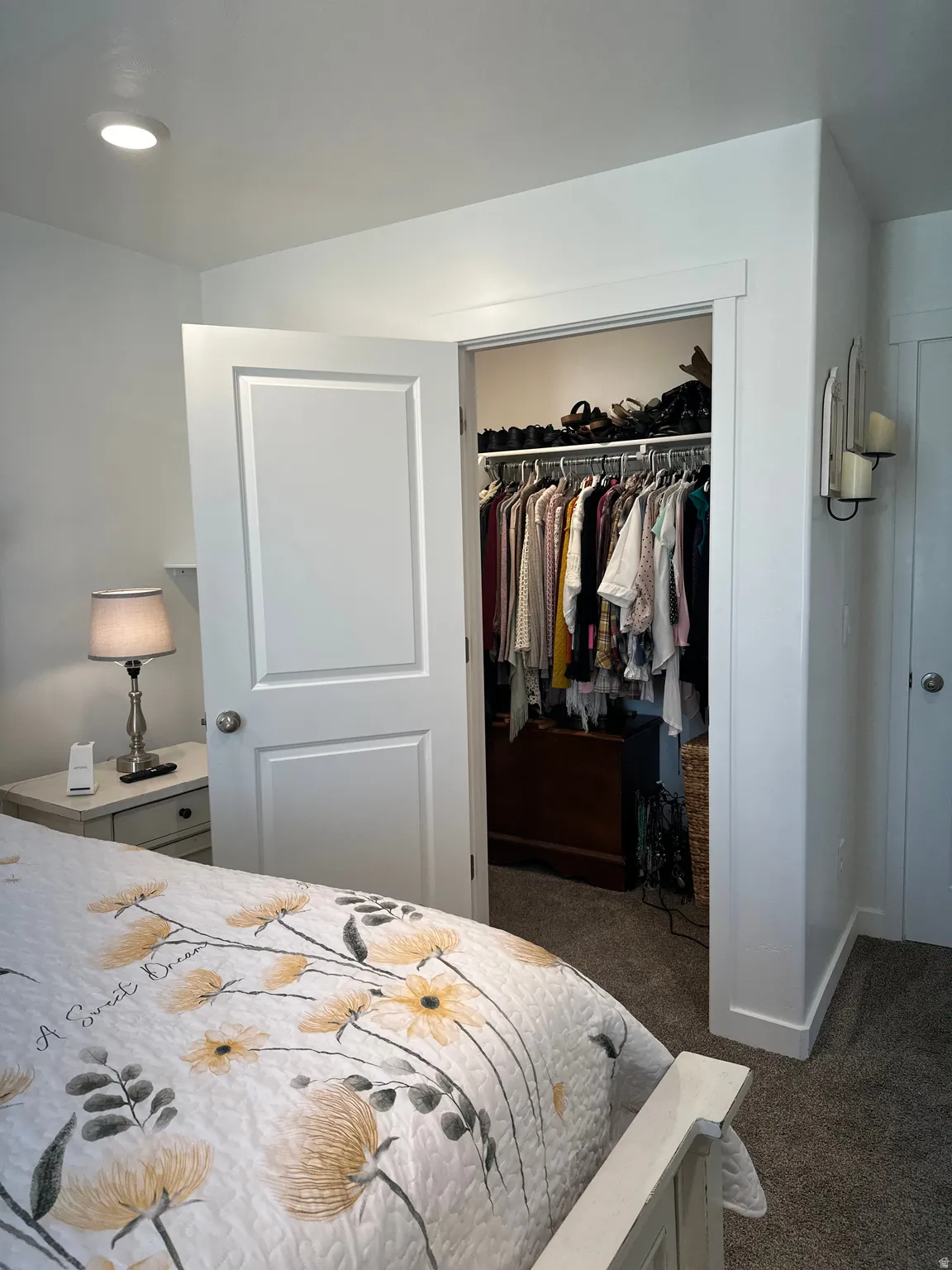 Bedroom featuring neutral wall paint, carpet flooring, a white paneled door, and recessed lighting