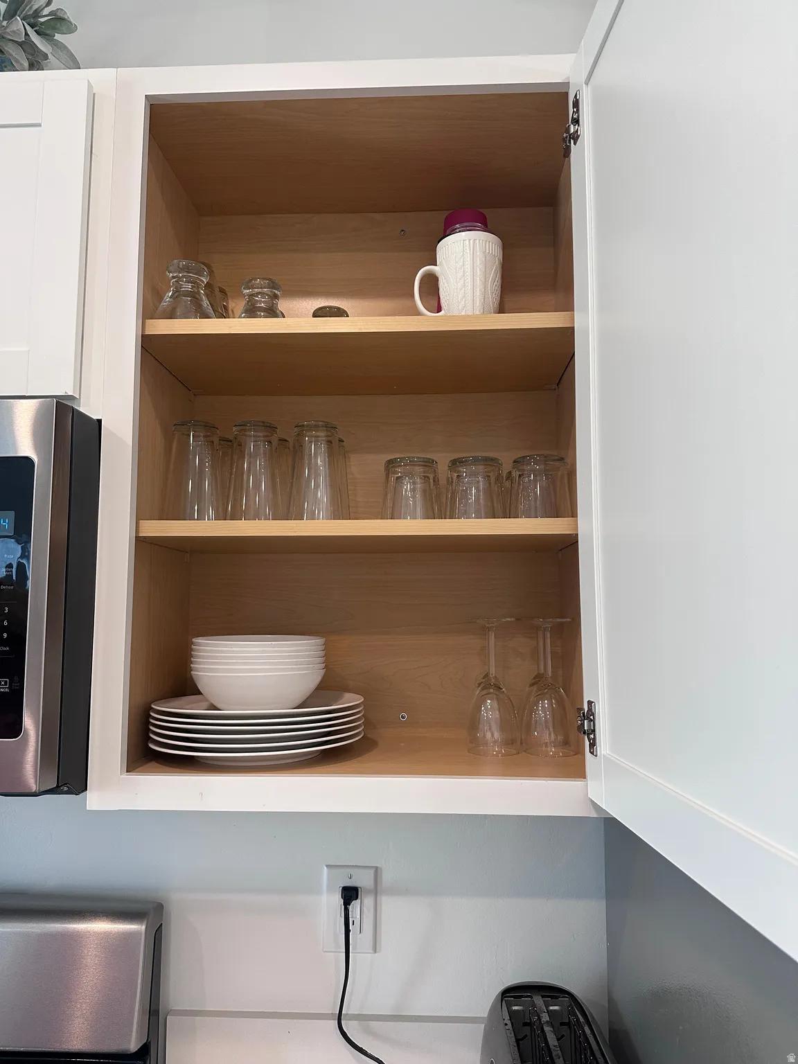 White cabinetry with light wood-finish interiors
