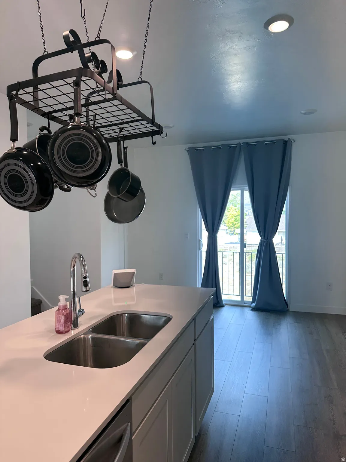 Kitchen island featuring a double basin stainless steel sink with a gooseneck faucet