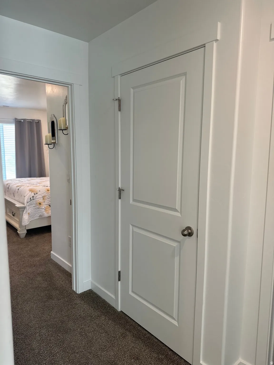 White two-panel interior door with a bronze knob