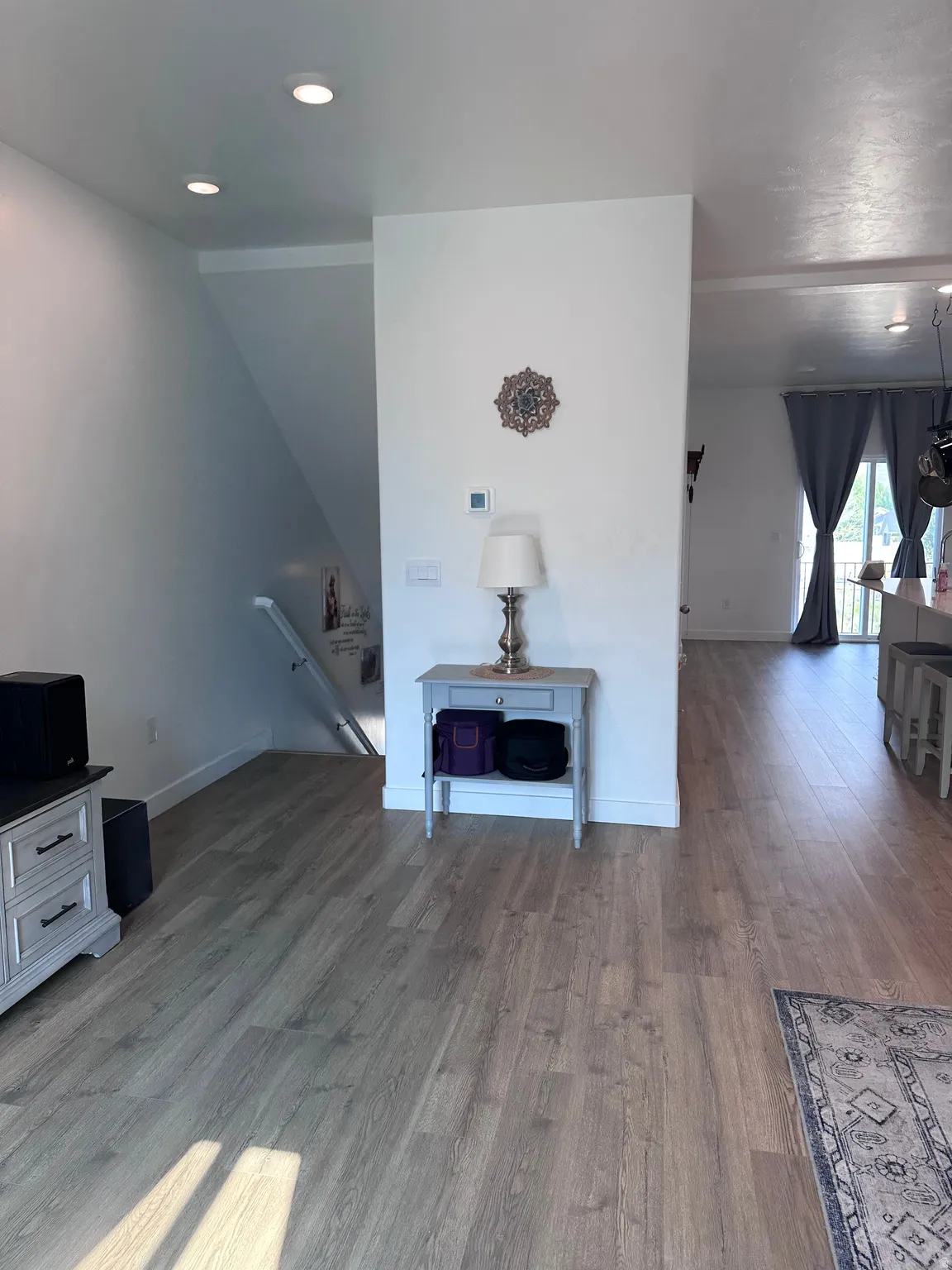 Open-concept living area featuring wood-finish flooring, recessed lighting, and white baseboards