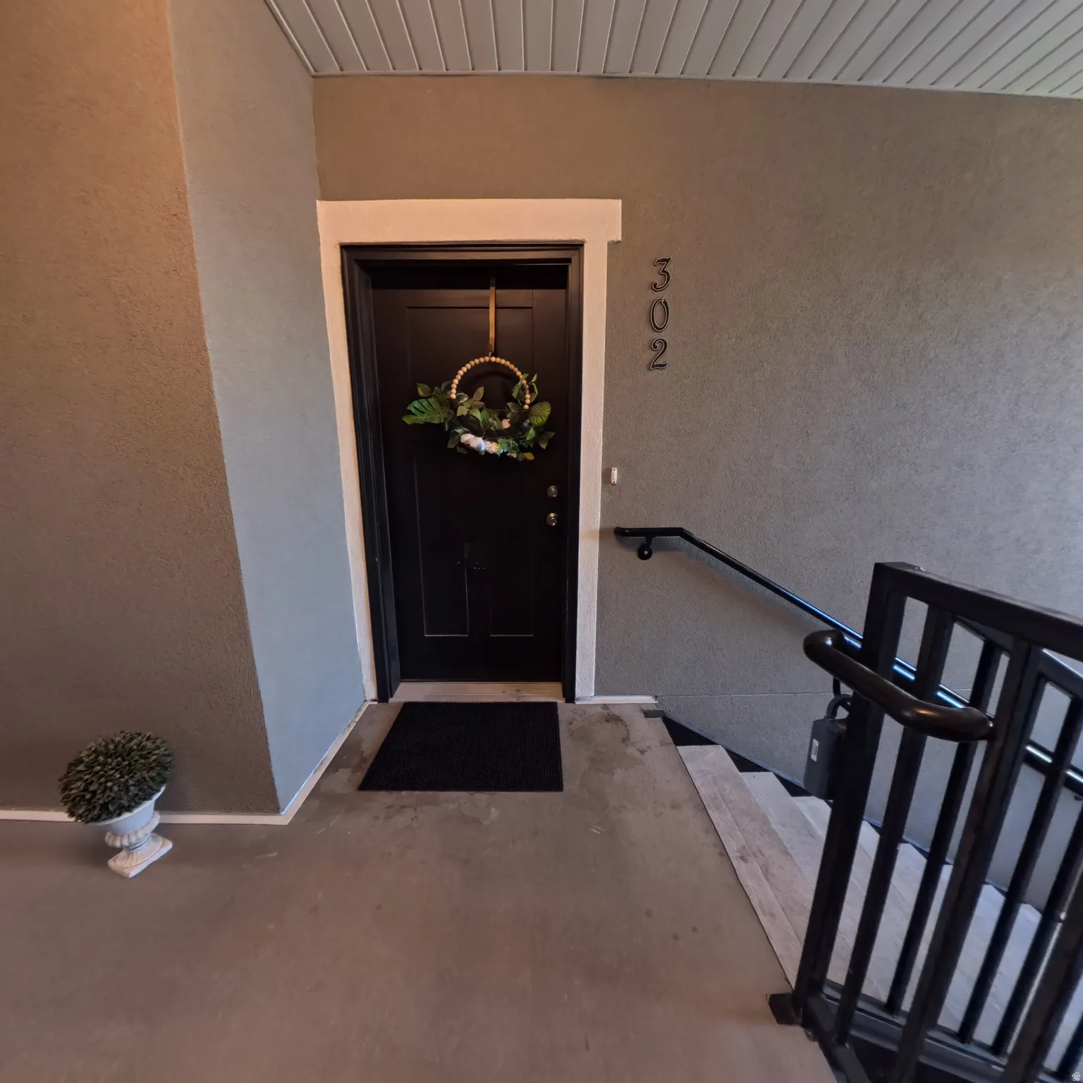 Entry door with panel detailing and contrasting white trim
