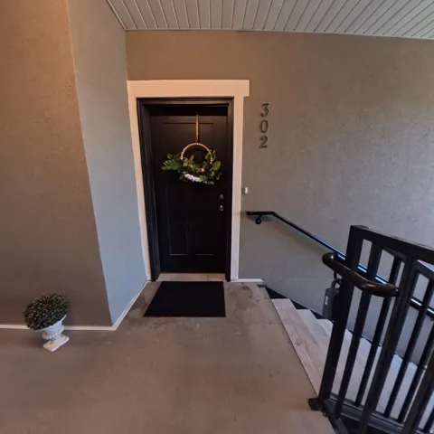 Entry door with panel detailing and contrasting white trim