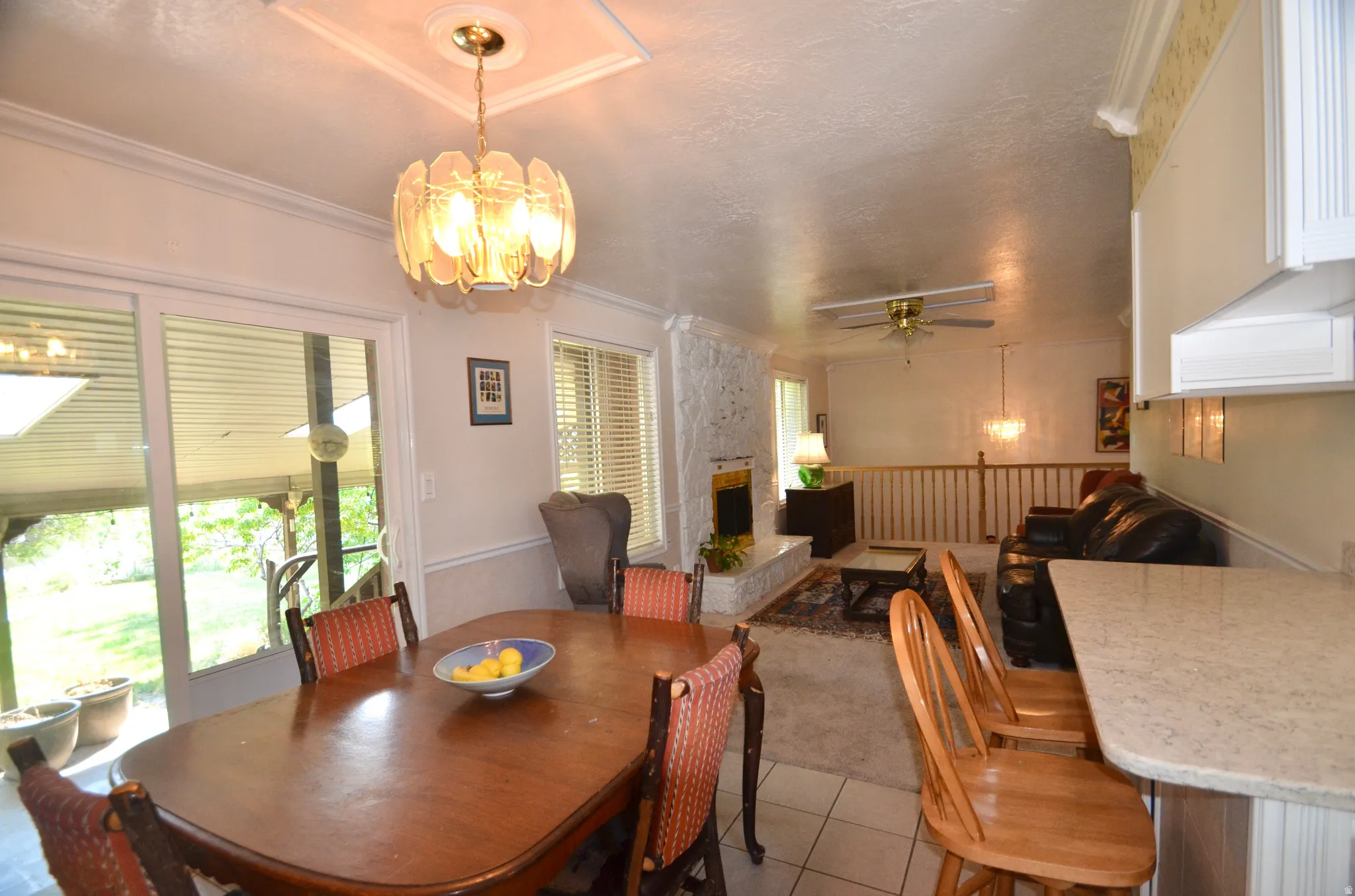 Dining area featuring a decorative chandelier, crown molding, and sliding glass door access to an outdoor space