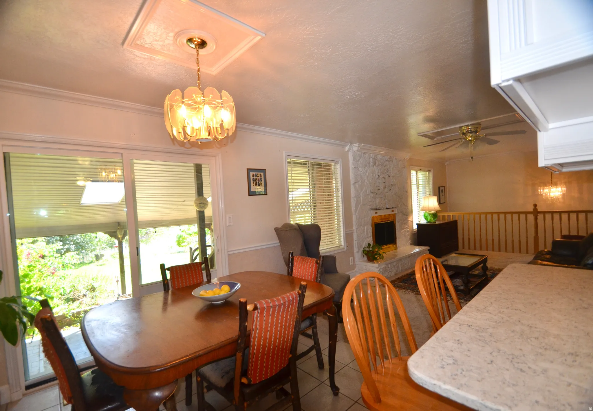 Dining area featuring a decorative chandelier, sliding glass doors to exterior, and tile flooring