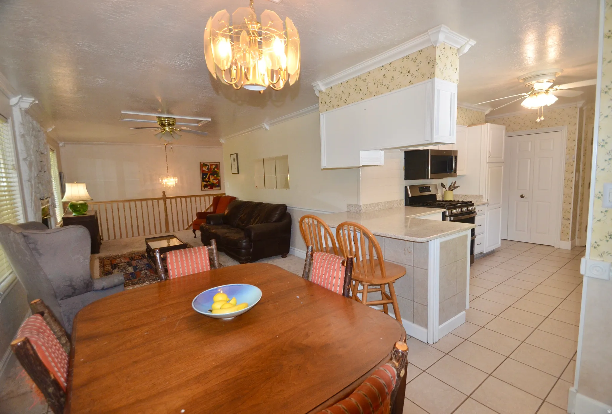 Dining area featuring a wood-finish dining table and an overhead chandelier light fixture
