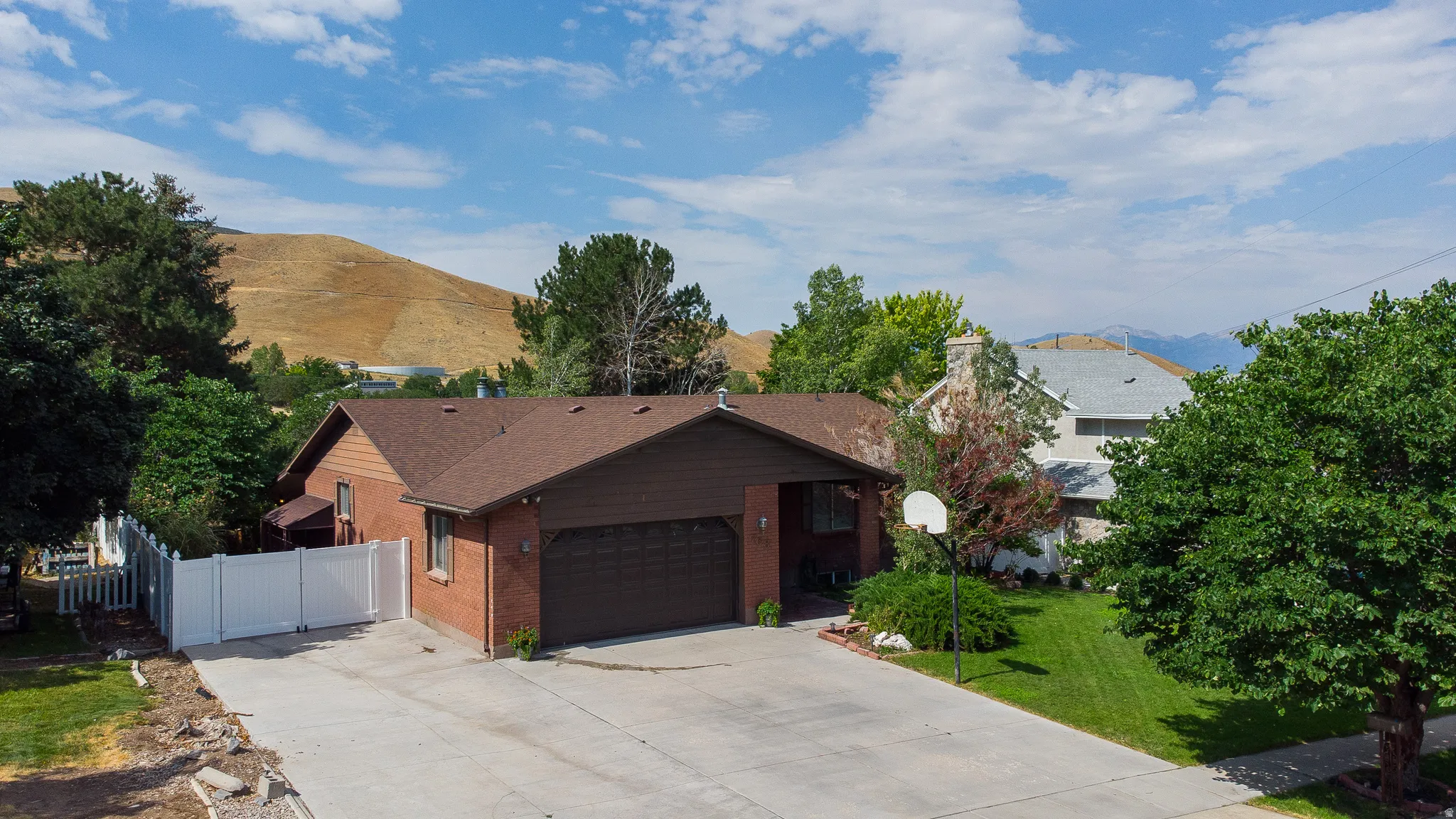 Brick exterior with a brown roof and an attached two-car garage
