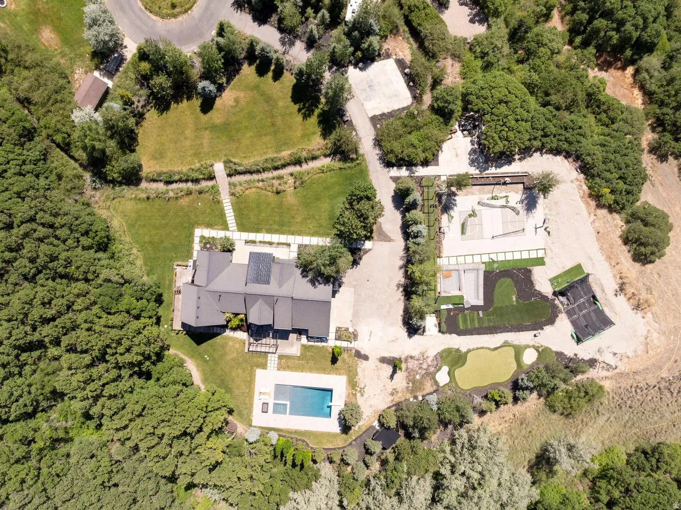 Property has swumming pool, spa, pickleball/basketball court, putting green, large storage vault and more...