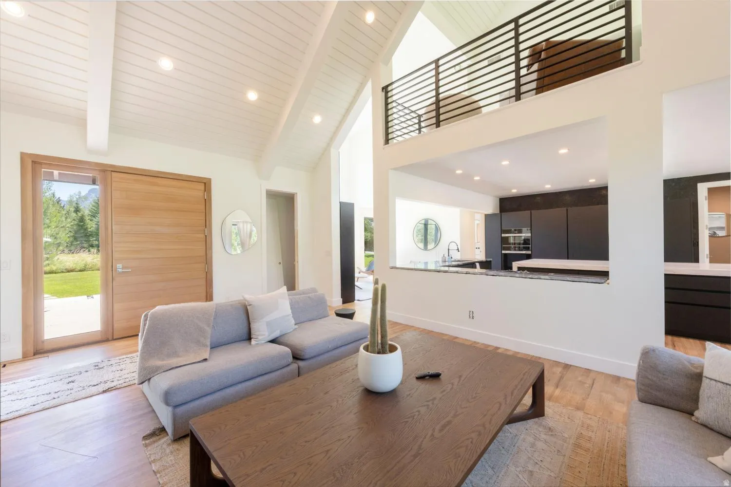 Entry coming in to kitchen great room with vaulted wood-paneled ceilings with recessed lighting