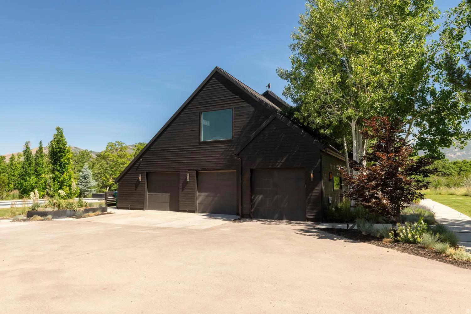 Extra wide 3 car garage with plenty of parking outside, including RV parking possibilitites