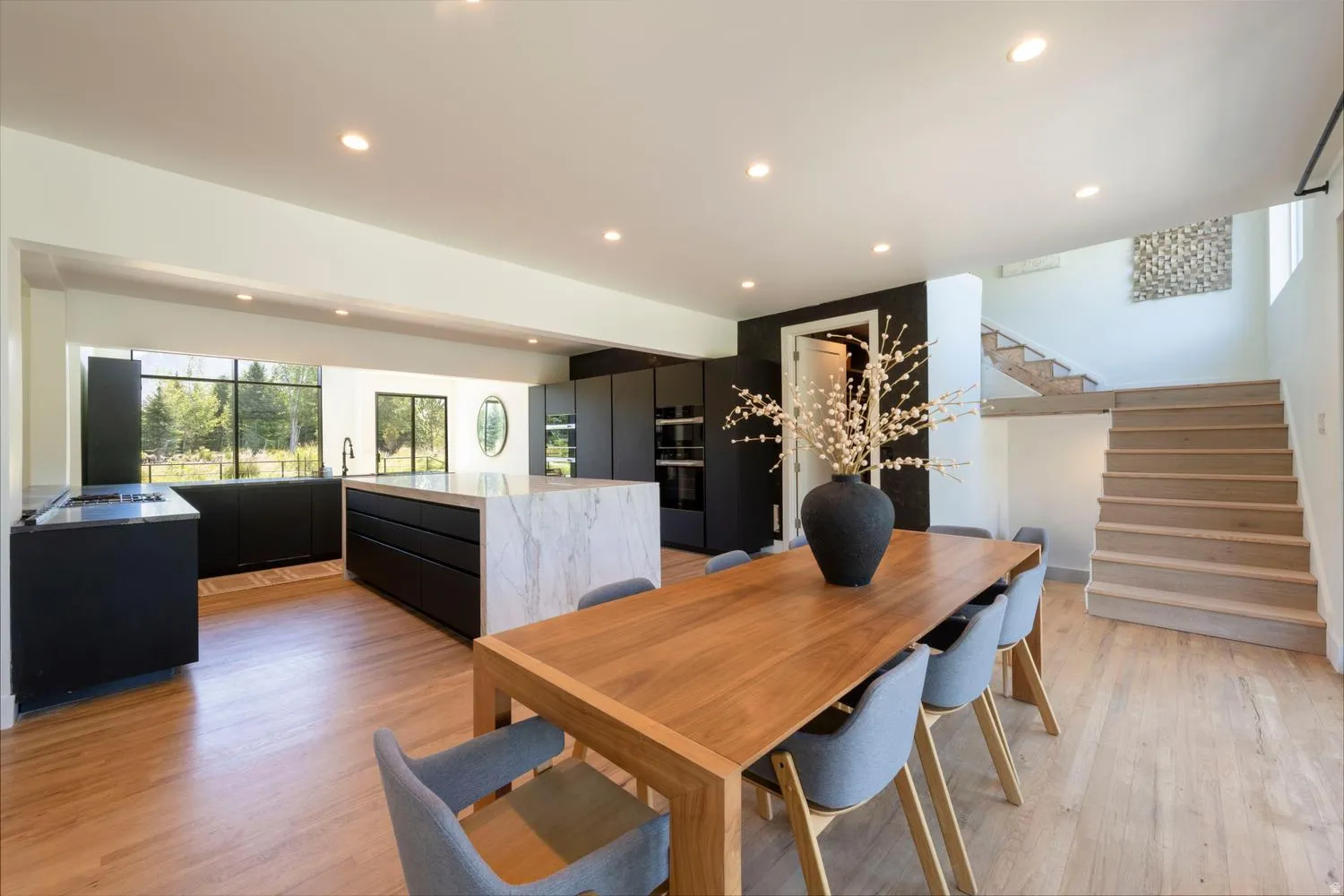 Open-concept main living area with wood-finish flooring