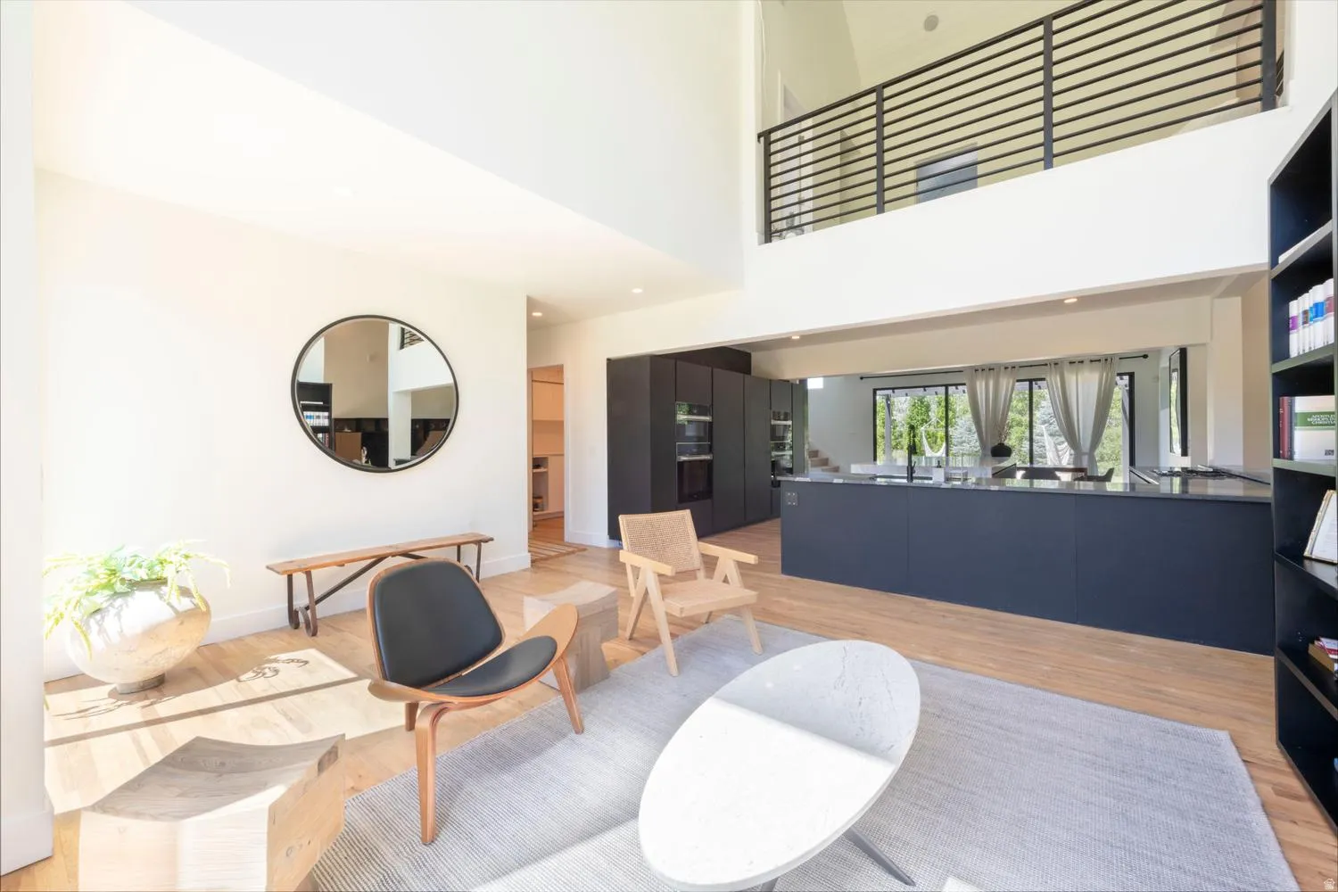 Open-concept living area with high ceilings and wood-finish flooring