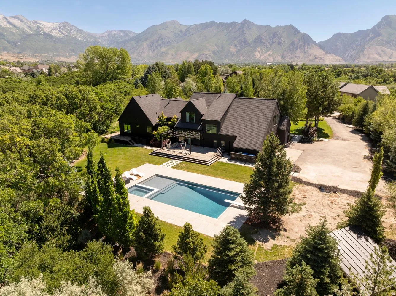Beautiful view looking east at pool and home with mountain backdrop