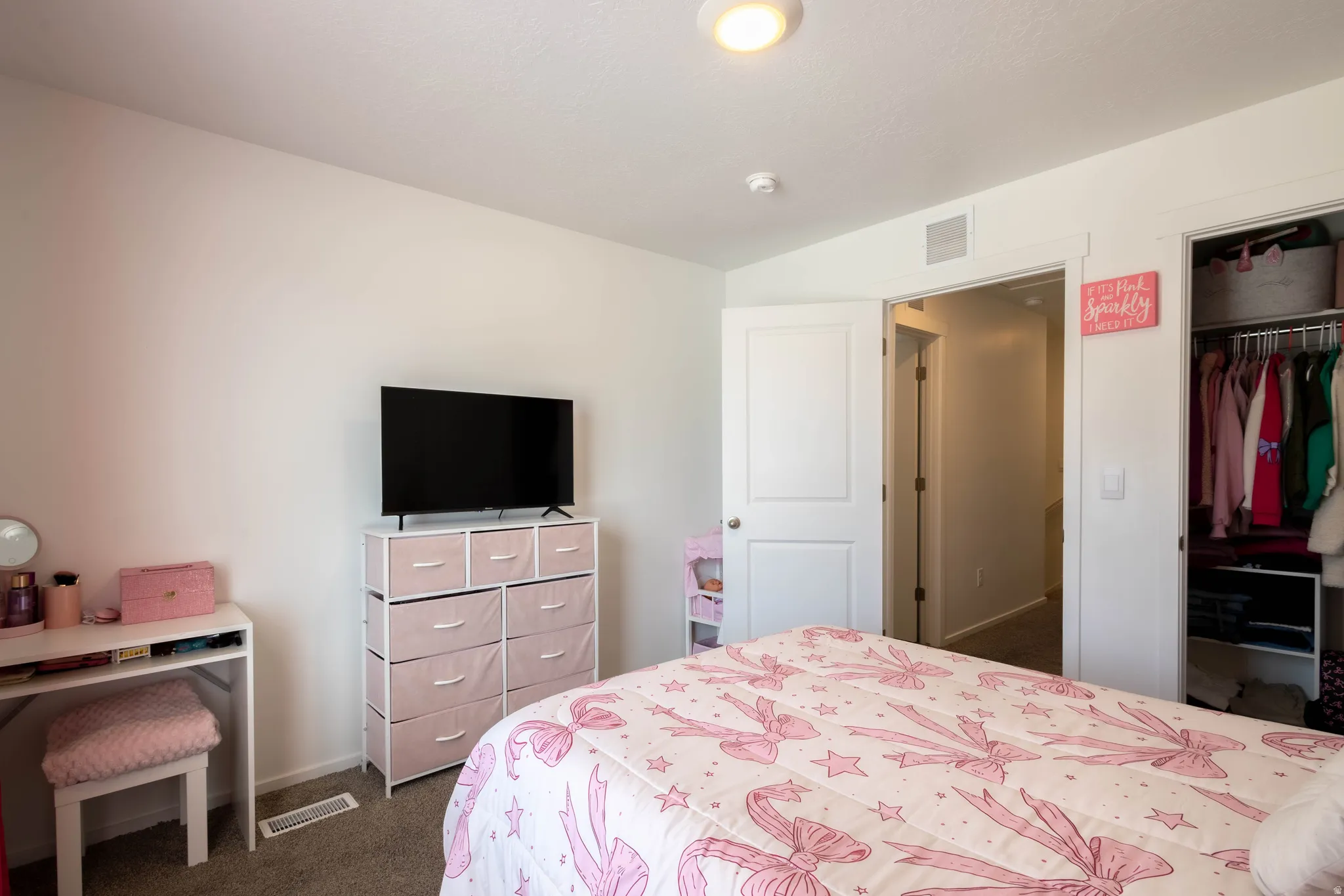 Bedroom featuring a built-in closet with shelving and hanging rods