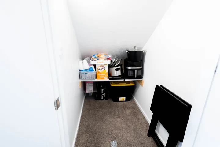 Storage under the stairs.