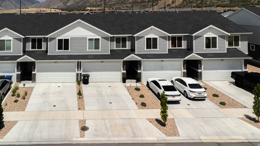 Modern townhome-style residences featuring gray siding and white trim