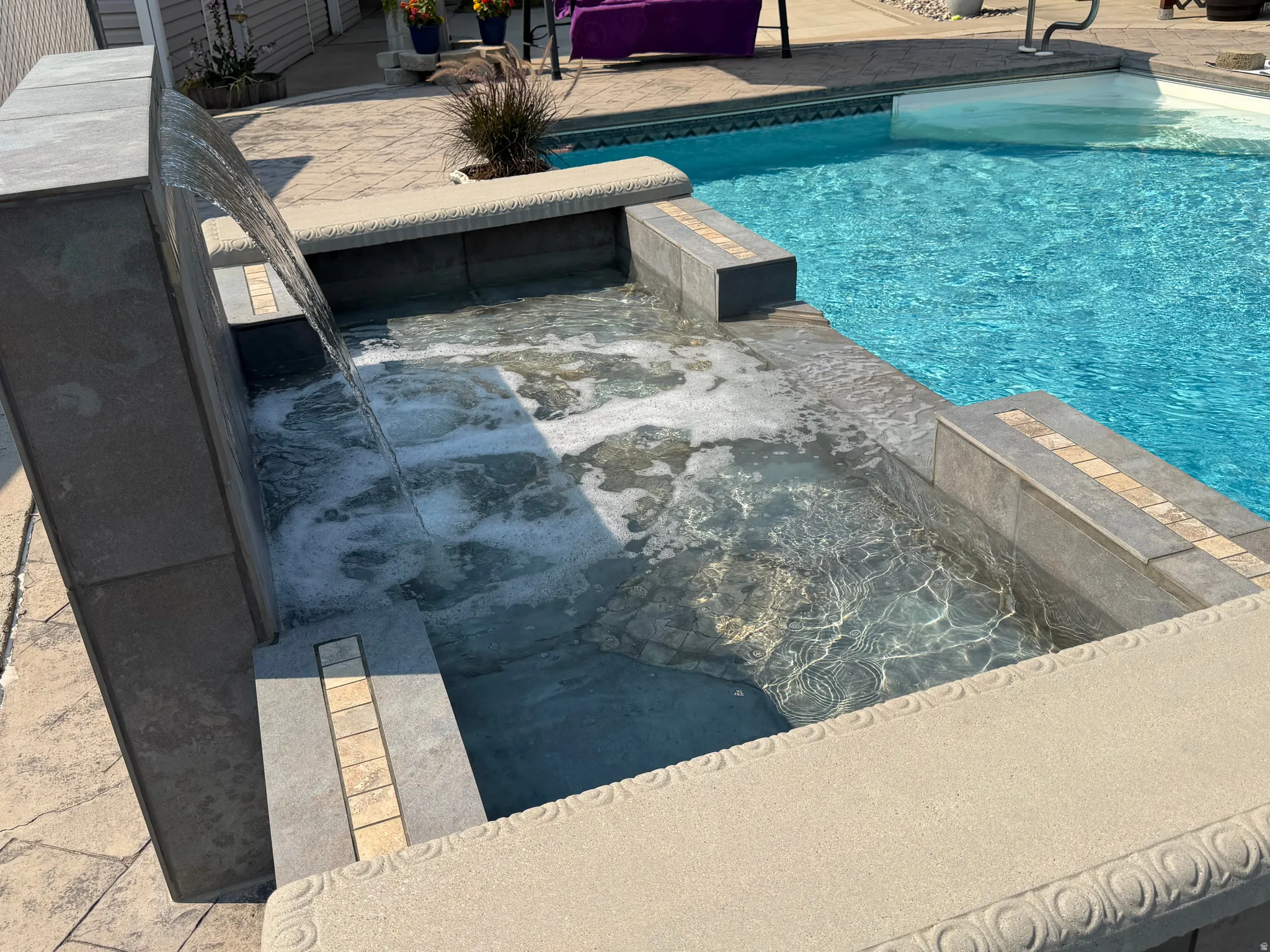 Built-in spa with integrated waterfall feature