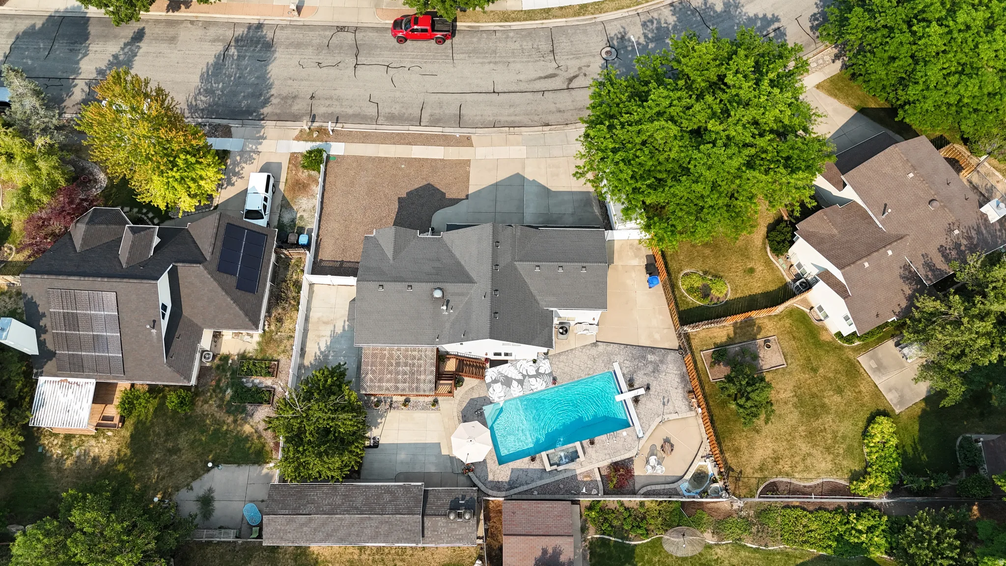 Outdoor living space featuring a rectangular swimming pool, integrated spa, and expansive paver patio