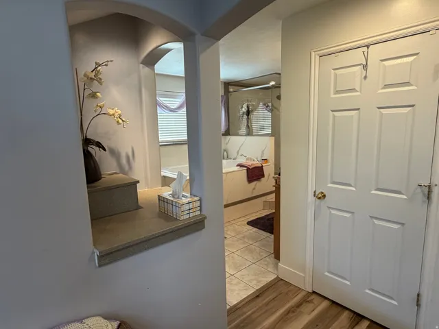Archway featuring a recessed display niche with tiered shelving