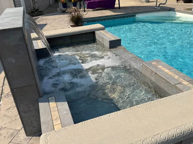 Built-in spa with integrated waterfall feature