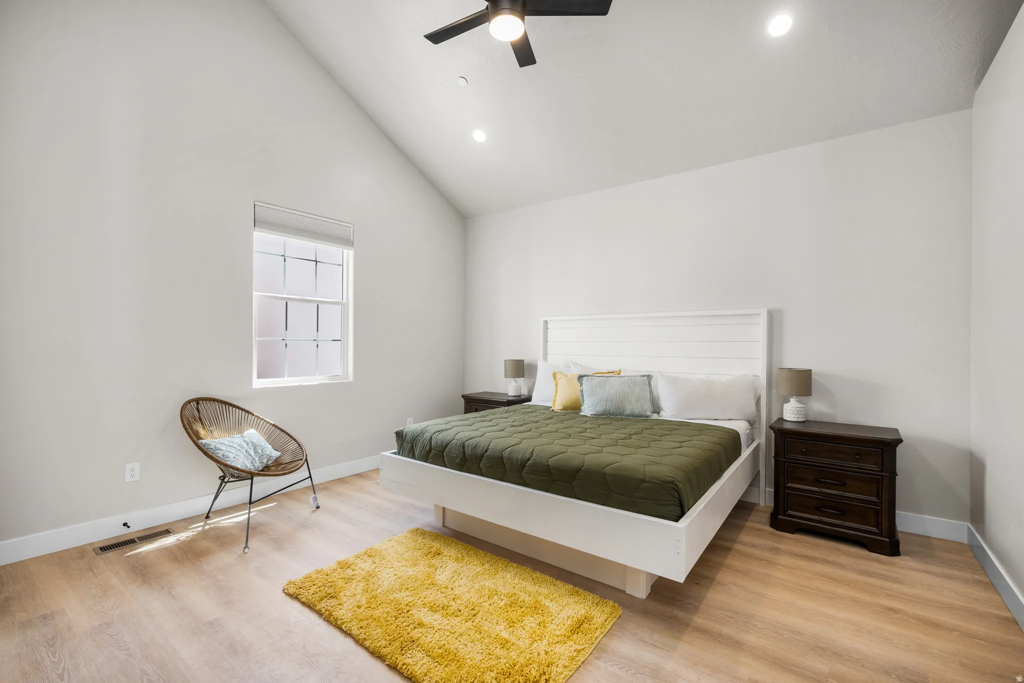 Bedroom featuring a vaulted ceiling, recessed lighting, and wood-finish flooring