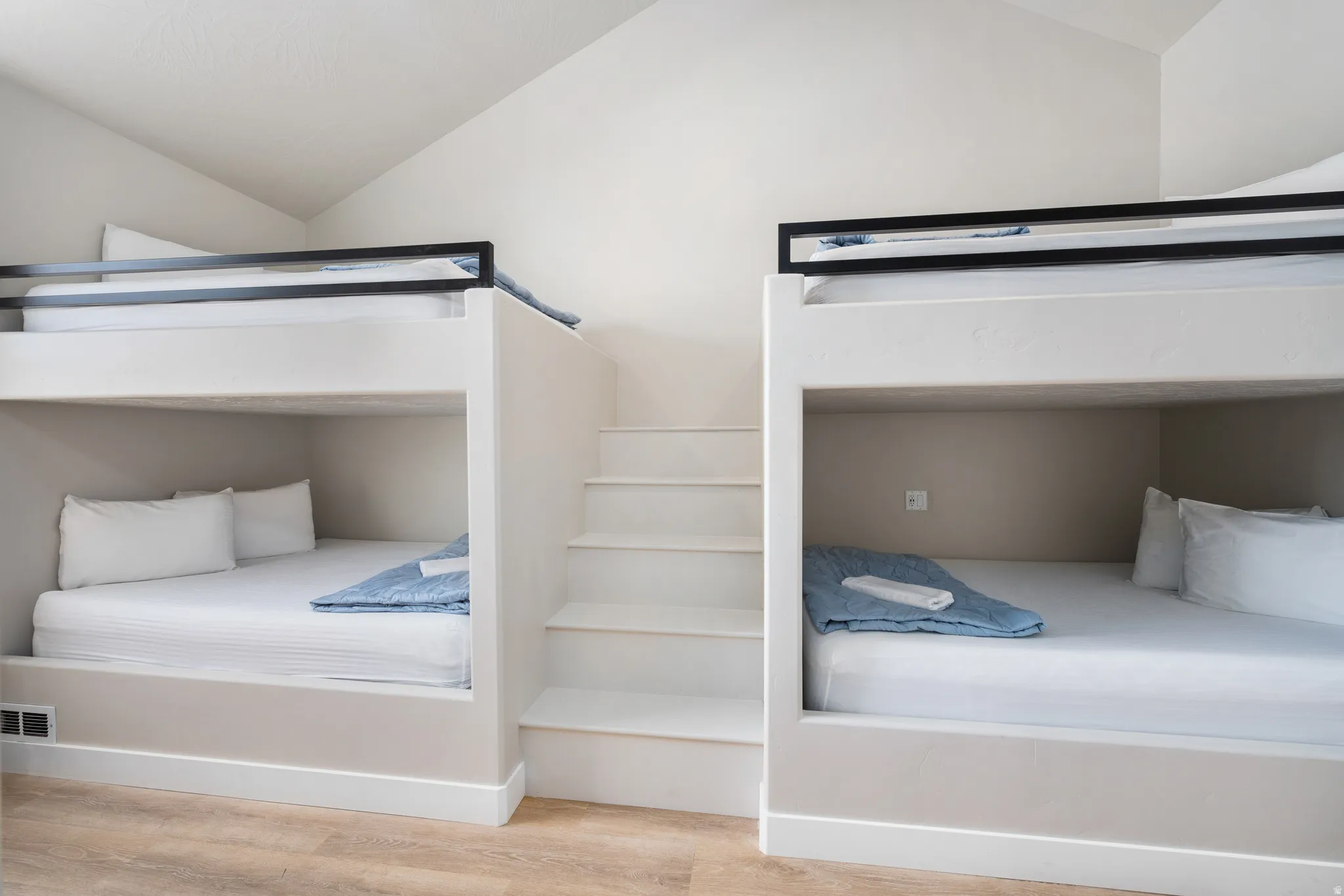 Custom built-in bunk beds featuring integrated stairs and white finishes