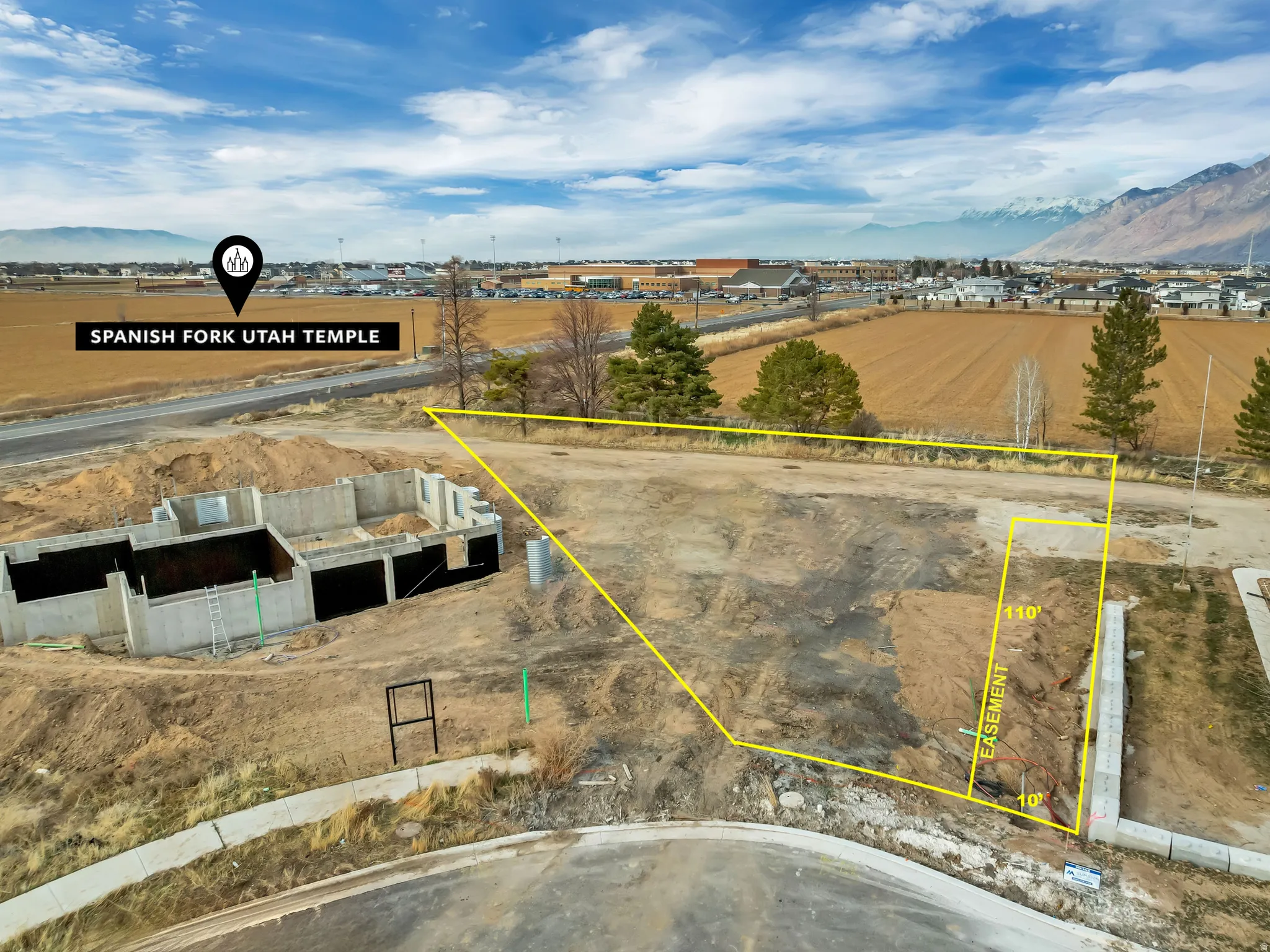 Partially excavated lot with visible foundation work and a cul-de-sac street