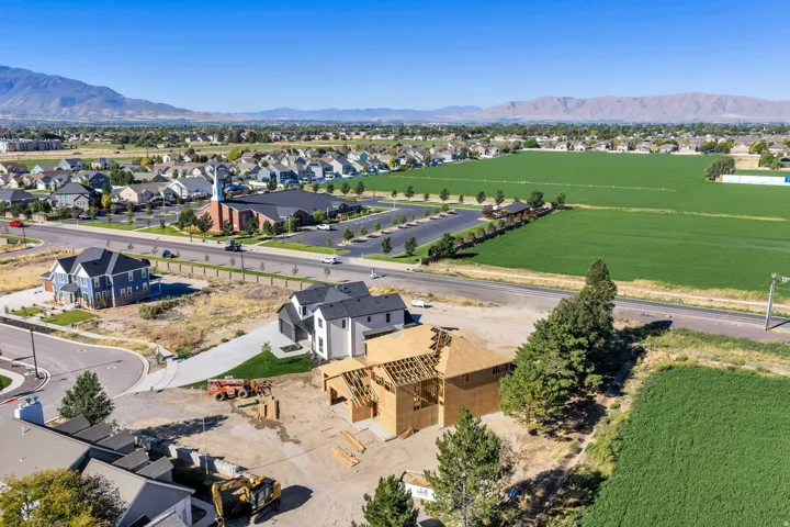 Expansive lot with partial framing, surrounding residential development, and distant mountainous scenery