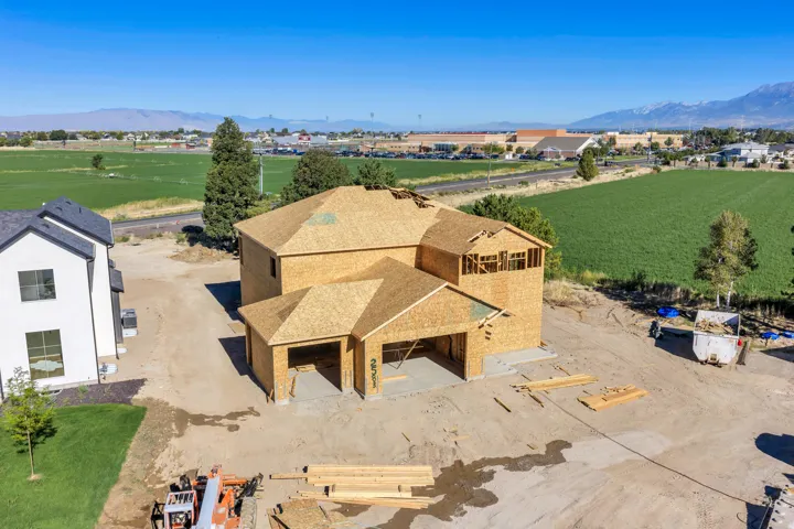 Framed structure featuring a multi-level design and an attached two-car garage