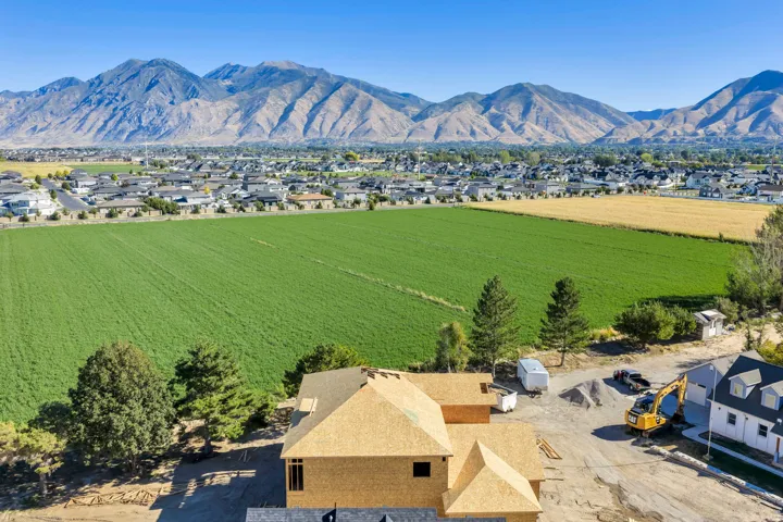 Expansive mountain backdrop with a substantial agricultural field