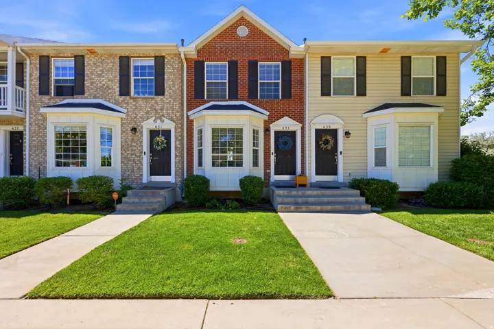 Townhome exterior featuring varied siding and brick facades