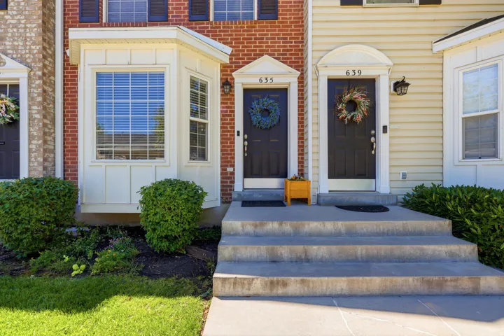 Brick and siding exterior featuring a prominent bay window with vertical blinds