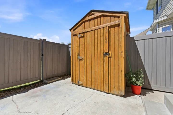 Exterior storage shed constructed from natural wood planks