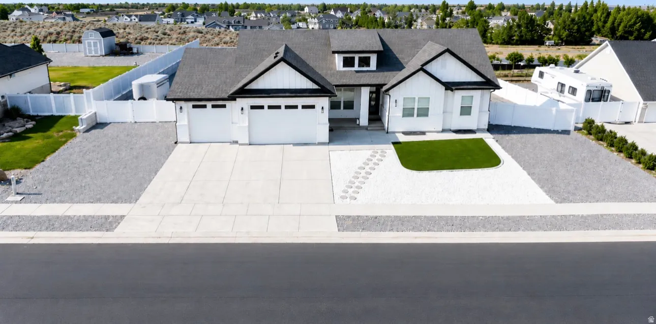 Contemporary ranch-style exterior featuring a white facade with black trim accents