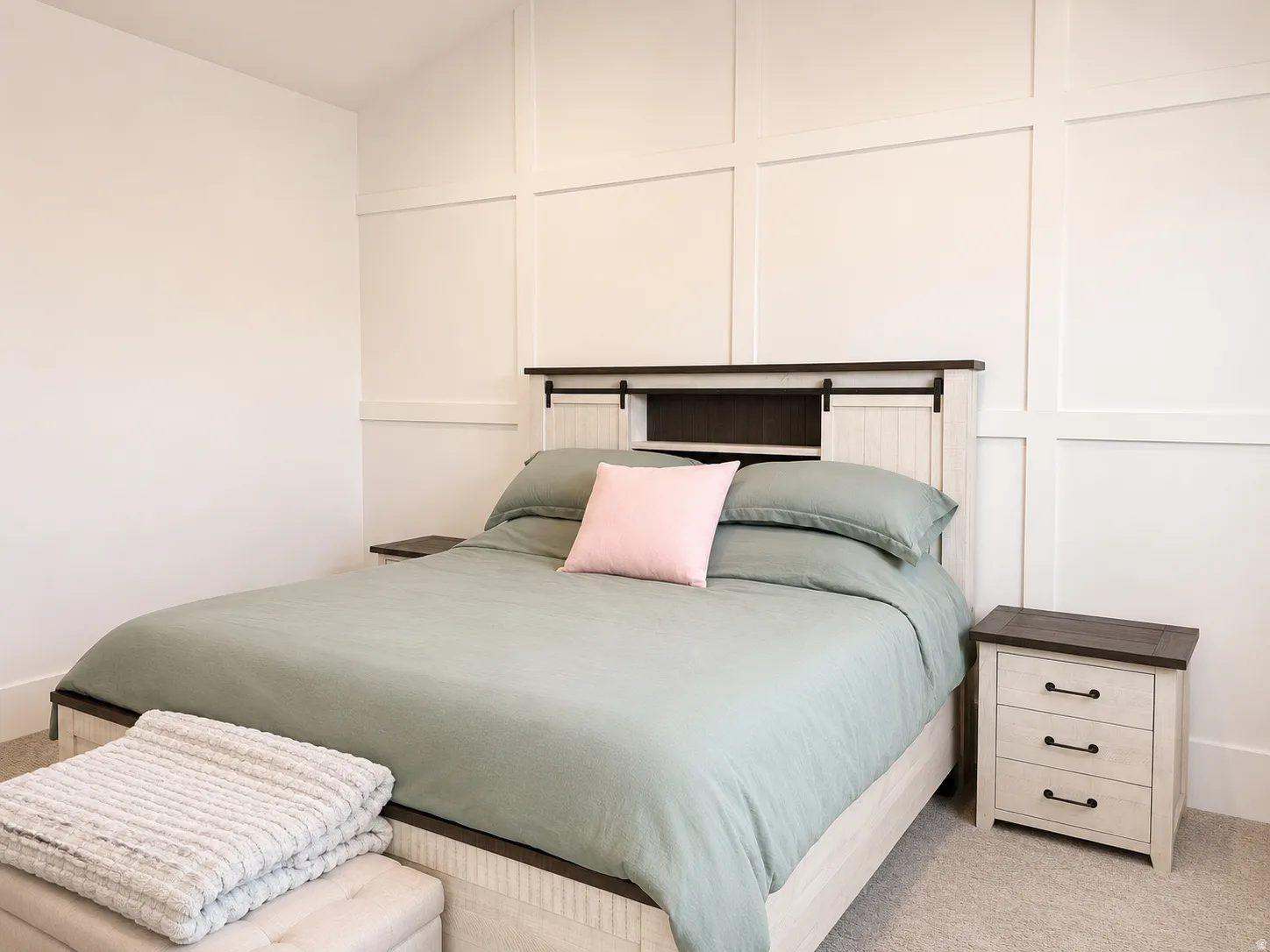Board and batten accent wall featuring a light-toned finish