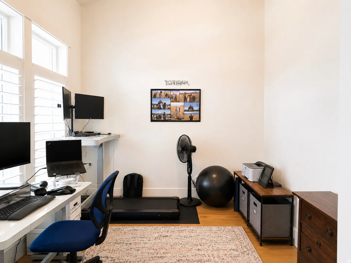 Dedicated room featuring light wood-finish flooring, white walls, and bright window shutters