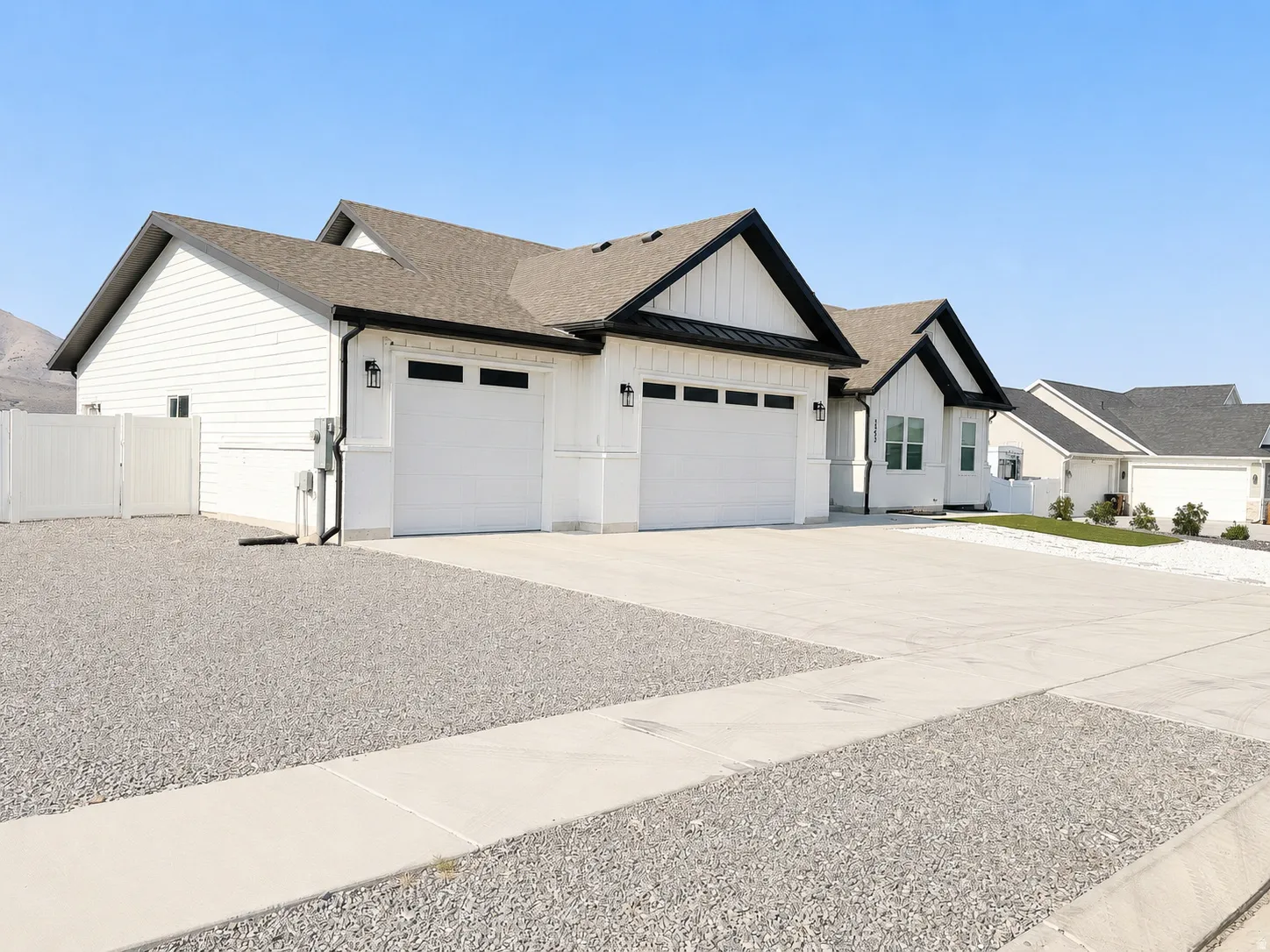Contemporary exterior with white siding and black trim accents