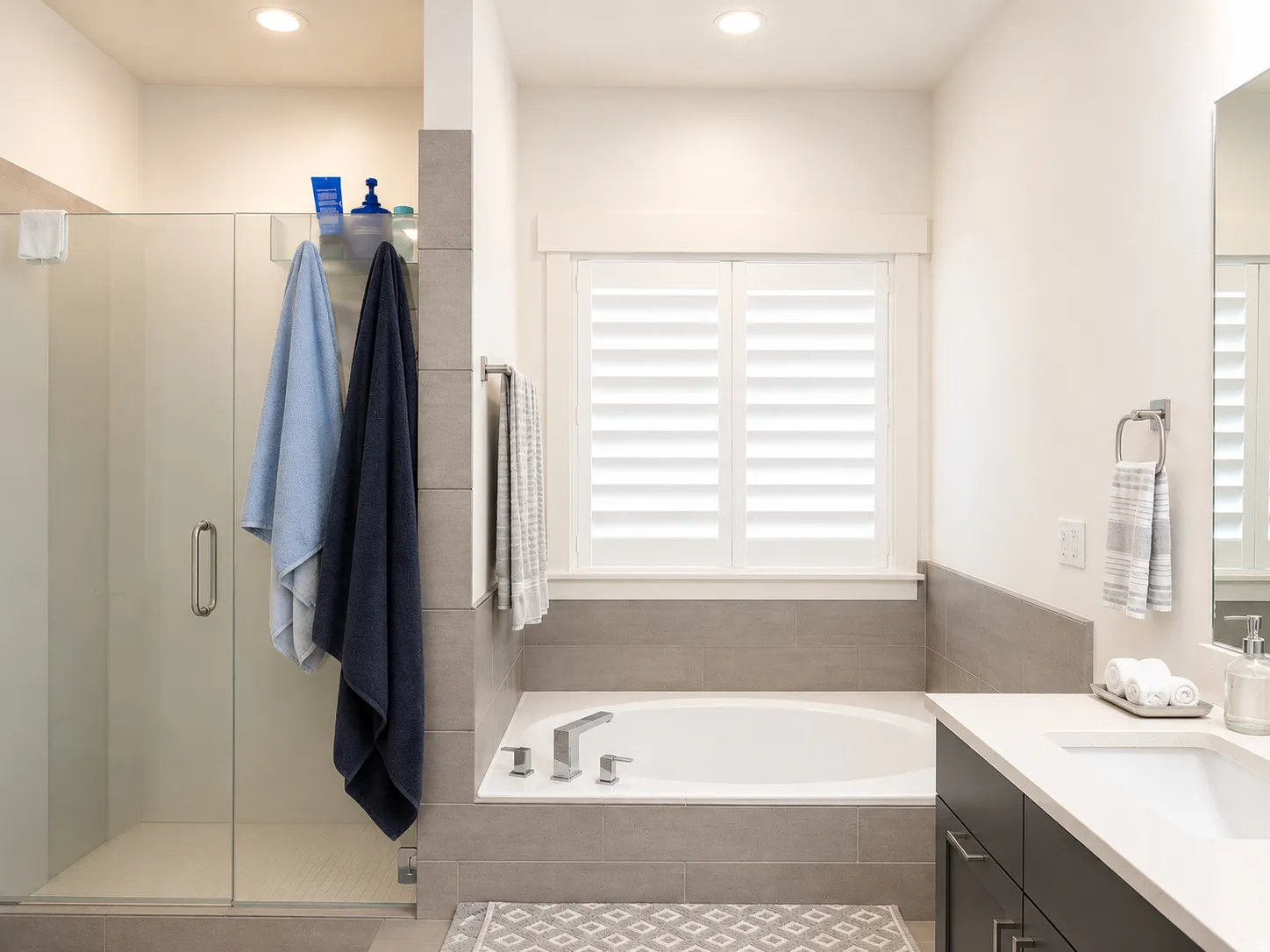 Bathroom featuring a built-in soaking tub, a walk-in shower with a glass enclosure, and a vanity with a rectangular undermount sink