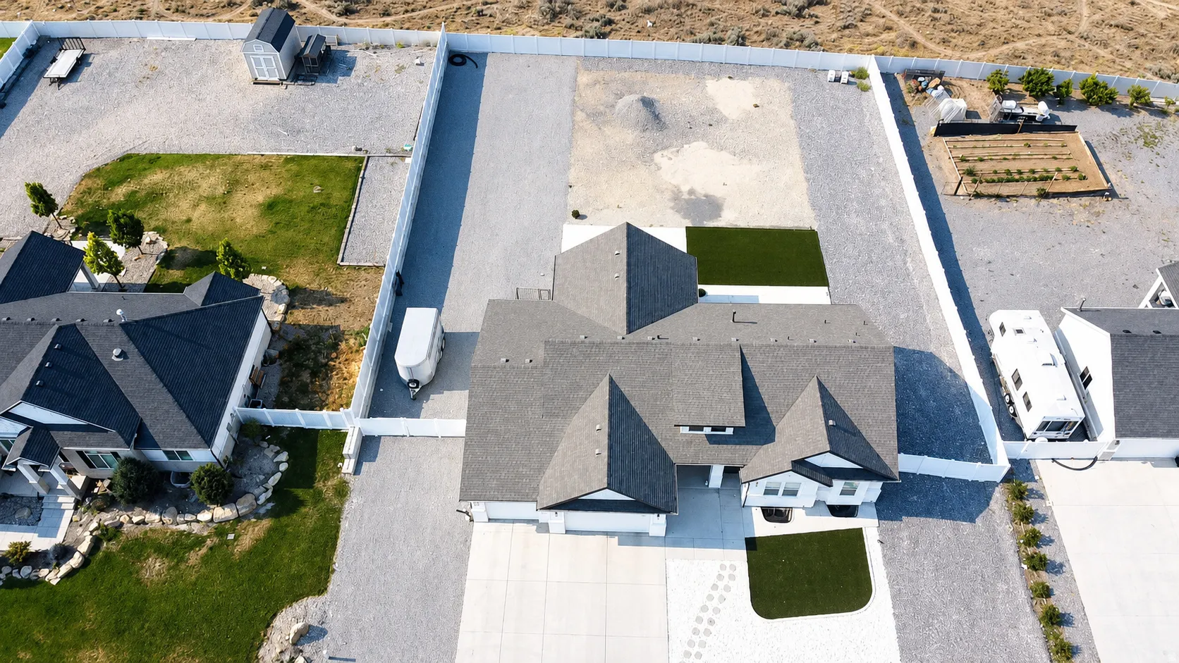 Aerial perspective showcasing a contemporary home with dark shingle roofing