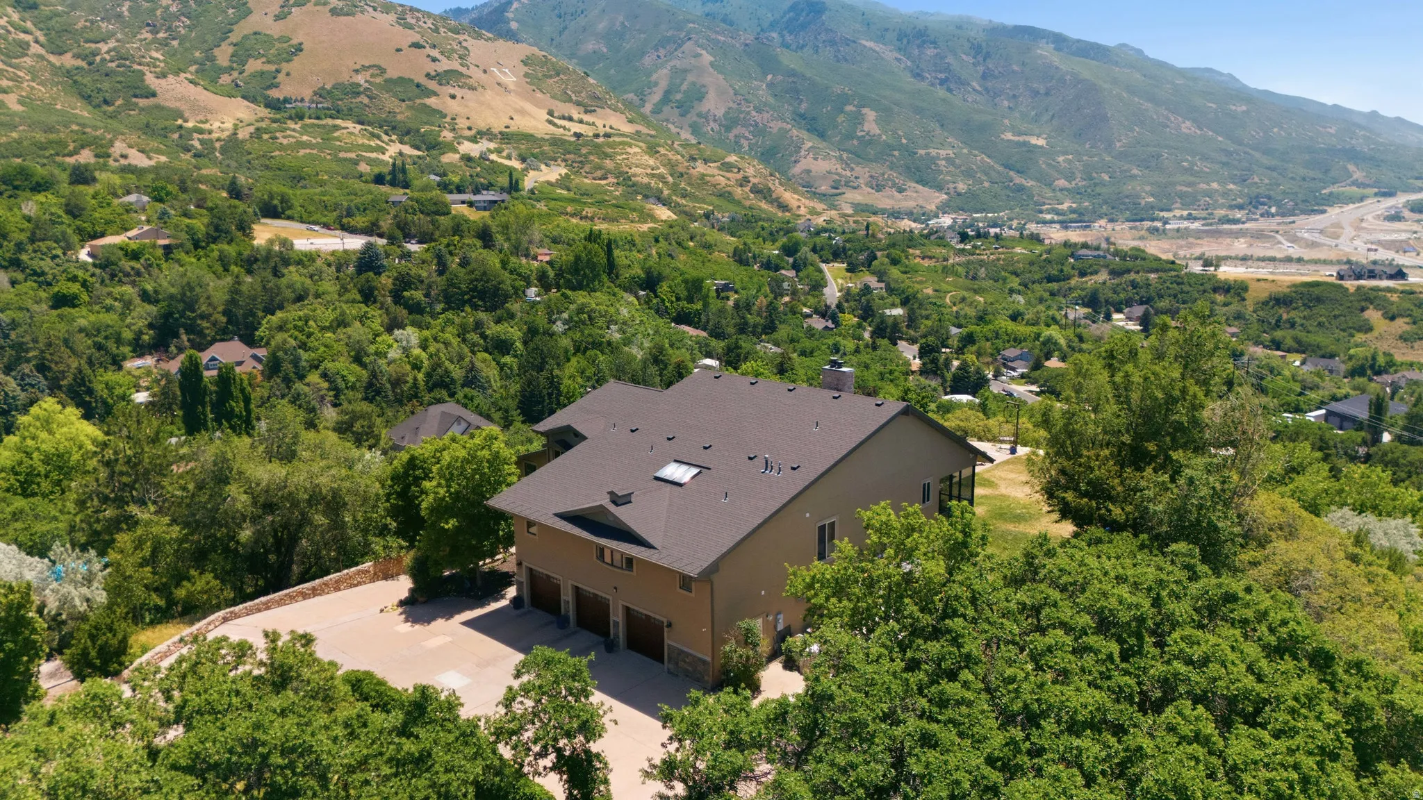 Expansive property featuring a multi-story residence with a three-car garage and a paved driveway
