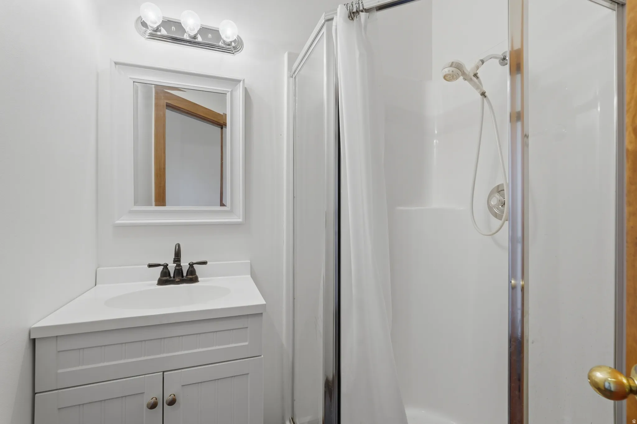 Compact pool bathroom featuring a corner vanity with a white countertop and integrated sink