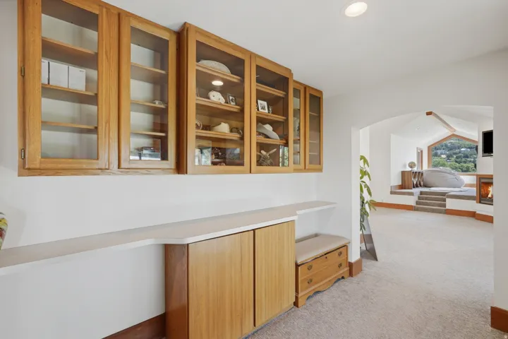 Built-in cabinetry with glass-front uppers and solid wood lower units