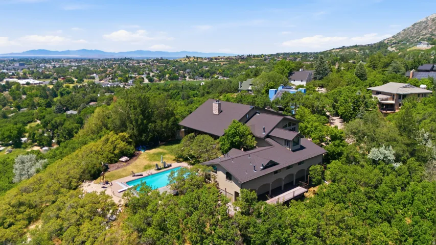 Expansive multi-level residence with a deep brown roof, featuring multiple gables and dormer windows