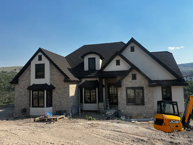 Stone and shingle exterior with dark trim accents