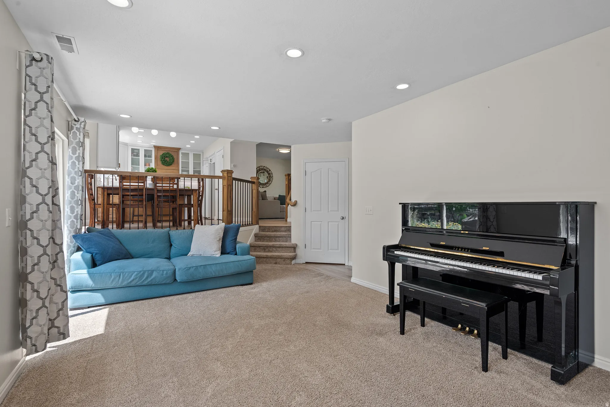 Carpeted living area with recessed lighting