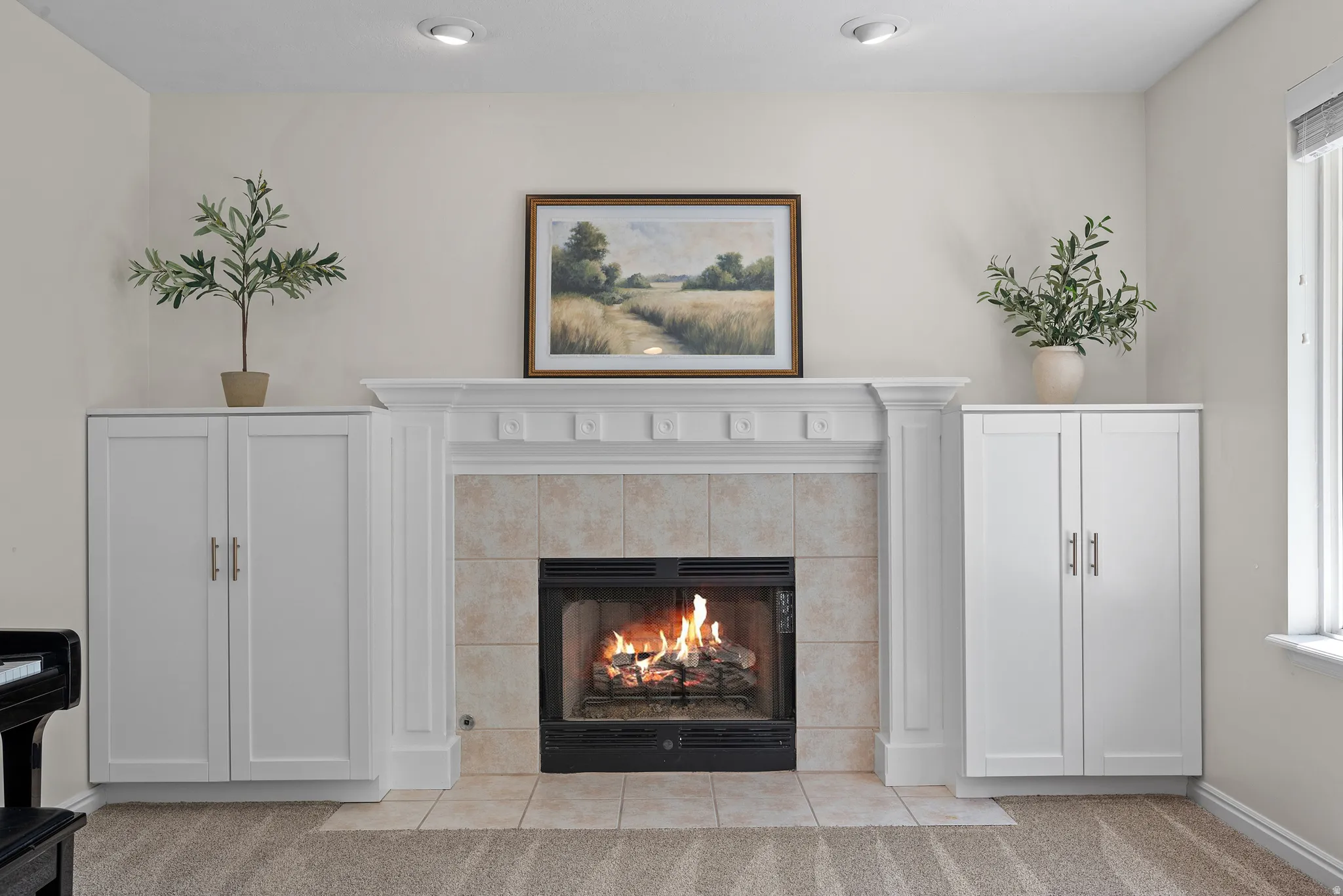 Fireplace featuring a decorative mantel, tile surround, and hearth
