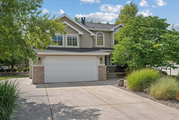Stucco exterior with stone accents and a two-car garage