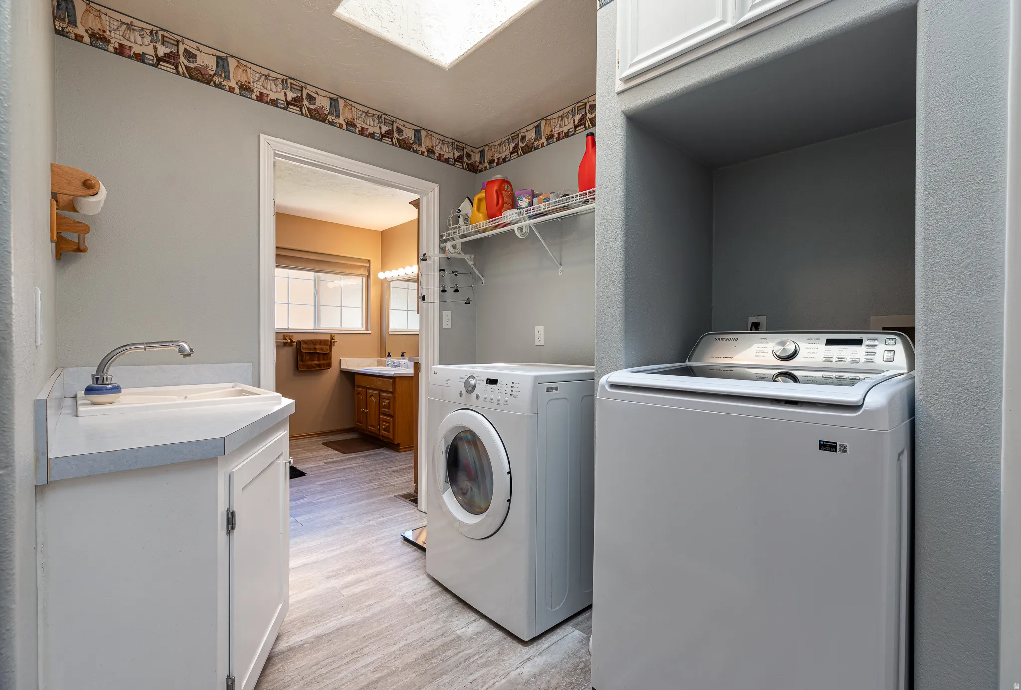 Utility room, washer and dryer and sink